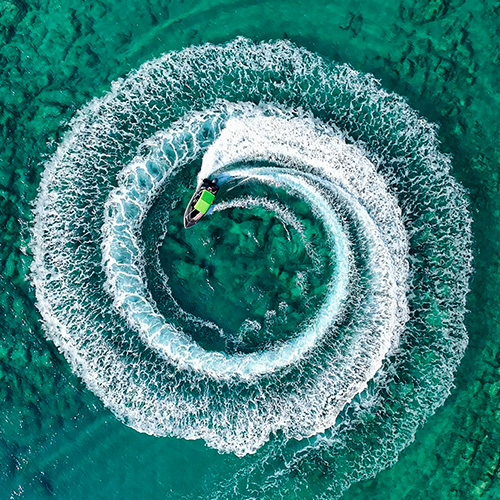 A jetski creating a spiral in the wake.